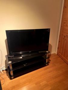 a large flat screen tv sitting on a stand at Large single-family home for rent World Cup 2025 in Trondheim