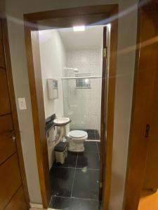 a small bathroom with a toilet and a shower at vitor hugo in Corumbá +14 photos