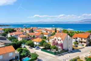 an aerial view of a town with houses and the ocean at Apartment Bracholet in Supetar