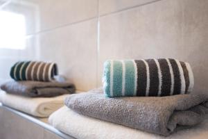 a group of towels on a shelf in a bathroom at Apartments Stella in Krk +50 photos