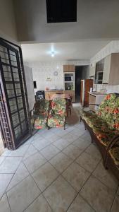 a kitchen with two couches and a table in a room at Cantinho das Marias in Itapoa +9 photos