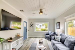 a living room with a couch and a table at 5 Mi to Dtwn Bright Home with Yard in Pensacola! in Pensacola