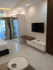 a living room with a tv on a wall at Hurghadiansrealty in Hurghada +4 photos