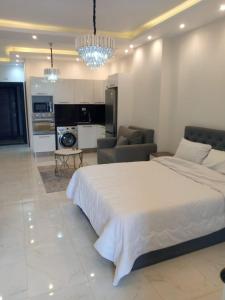 a bedroom with a large bed and a living room at Hurghadiansrealty in Hurghada