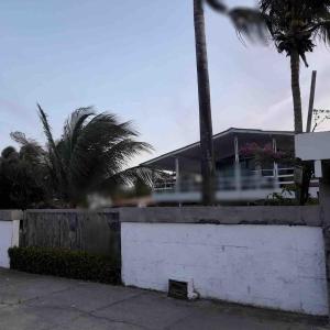 a blurry picture of a building with palm trees at Casa na Frente da Praia do Maçarico in Salinópolis