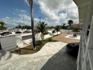 a balcony of a house with a palm tree at Casa na Frente da Praia do Maçarico in Salinópolis