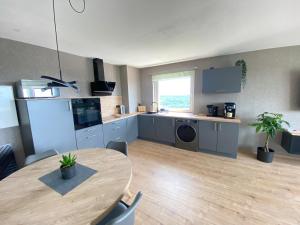a kitchen with a wooden table and a table and a dining room at Apartment Weitblick in Braunschweig