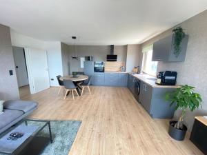 a kitchen and living room with a couch and a table at Apartment Weitblick in Braunschweig +5 photos