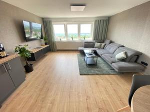a living room with a couch and a table at Apartment Weitblick in Braunschweig
