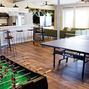 a ping pong table with rackets on it in a room at Sojourn The Lighthouse Beach Front Resort Villa in North Camellia Acres