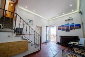 a living room with a staircase and a fireplace at Appartamento Annunziata in Naples