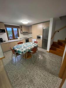 a kitchen with a table and chairs in a room at Cabana Irina Băile Figa in Beclean