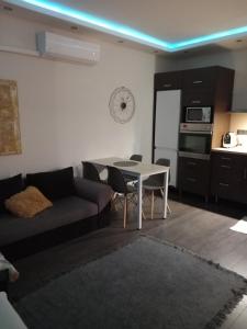 a living room with a couch and a table at Roli Apartman in Nyíregyháza
