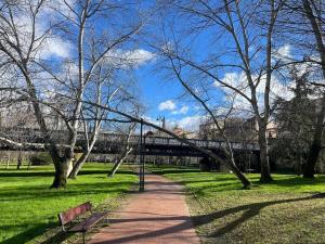 a park with a path and trees and a bridge at Ruavieja, camino y vino in Logroño +24 photos