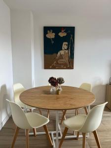 a dining room with a wooden table and chairs at Ruavieja, camino y vino in Logroño