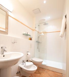 a bathroom with a sink and a toilet and a shower at Hotel Drei Raben in Nuremberg +48 photos