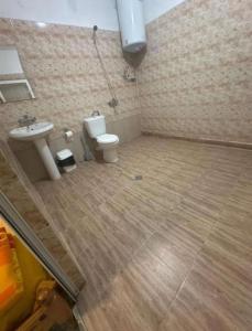 a bathroom with a toilet and a sink at Хотел Елит in Kostinbrod