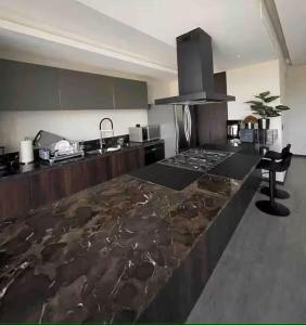a kitchen with a counter top and a stove at Colonia Americana Vista Home in Guadalajara