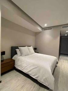 a bedroom with a large white bed in it at Colonia Americana Vista Home in Guadalajara +5 photos