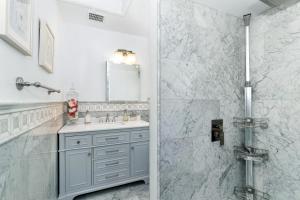 a white bathroom with a sink and a shower at Sanctuary-5BR Home for Extended Stays & Family Comfort in Spokane