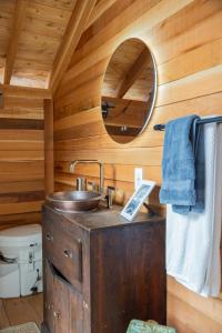 a wooden bathroom with a sink and a mirror at Lux Remote Glamping Hideaway in Ucluelet +81 photos