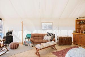 a living room with a couch in a tent at Lux Remote Glamping Hideaway in Ucluelet