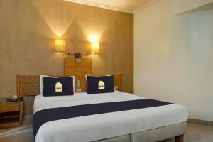 Postel nebo postele na pokoji v ubytování Townhouse Oak Orchard Hotel