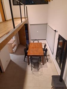 a room with a table and chairs and a board at Alto del pinar in Mar Azul