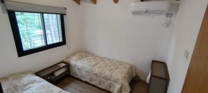 a small room with a couch and a window at Alto del pinar in Mar Azul