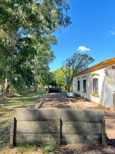a wooden bench in front of a building at La Danesa - Casa de campo en la naturaleza a 25 min del centro in Tandil +51 photos