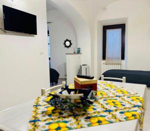 a living room with a table with a colorful blanket at Casa vacanza Città dei Papi Anagni in Anagni
