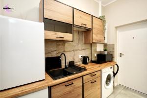 a kitchen with a sink and a microwave at MMRent Manhattan Room in Gdańsk +14 photos