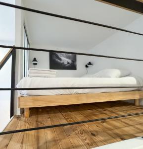 a bedroom with a bed with a black frame at Athéna in Caen