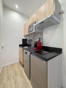 a kitchen with a stove and a counter top at Athéna in Caen