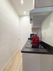 a kitchen with a stove and a counter top at Athéna in Caen +8 photos