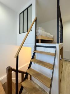 a staircase in a room with a window at Athéna in Caen