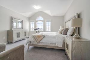 a white bedroom with a large bed and two windows at The Bliss in Bowmanville +24 photos