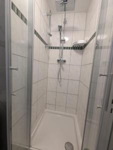 a shower with a glass door in a bathroom at La vins in Bremen