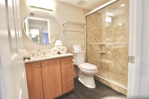 a bathroom with a toilet and a sink and a shower at Seaside Escape in Fort Pierce
