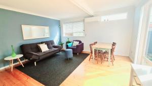 a living room with a couch and a table at At College Avenue in Prospect