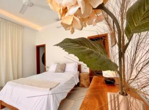 a room with a bed and a tree in it at 5 Bedroom Villa With Daily Housekeeping in Las Terrenas +21 photos