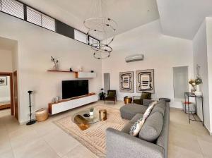 a living room with a couch and a tv at 5 Bedroom Villa With Daily Housekeeping in Las Terrenas