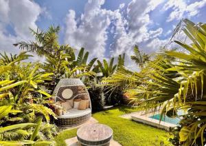 a garden with a garden seat in the grass at 5 Bedroom Villa With Daily Housekeeping in Las Terrenas