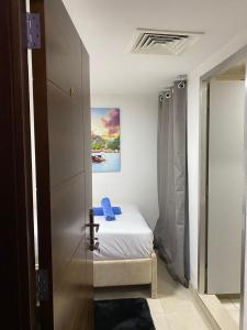 a bedroom with a bed and a painting on the wall at Affordable Master Room For Couple in Abu Dhabi