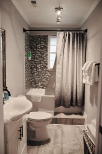 a bathroom with a toilet and a sink and a tub at Spacious 3 Bedroom , 1 Bath House Pet friendly in Red Top