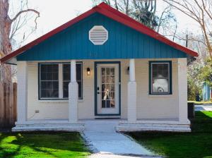 a small white and blue house with a red roof at Spacious 3 Bedroom , 1 Bath House Pet friendly in Red Top