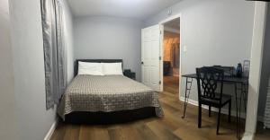 a bedroom with a bed and a table and a desk at Spacious 3 Bedroom , 1 Bath House Pet friendly in Red Top