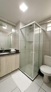 a bathroom with a glass shower and a toilet at West flat Studio40 na Nova Betânia - INNOVA in Mossoró