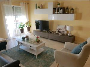 a living room with a couch and a coffee table at DOWNTOWN-GuestHouse in Olhão
