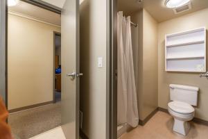 a bathroom with a toilet and a shower at Vancouver Island Residences in Nanaimo +27 photos